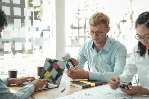 User experience UX designer designing web on smart phone layout. UI developer Stock Photos