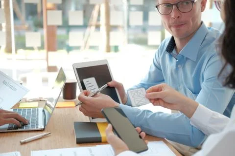 User experience UX designer designing web on smart phone layout. UI developer Stock Photos