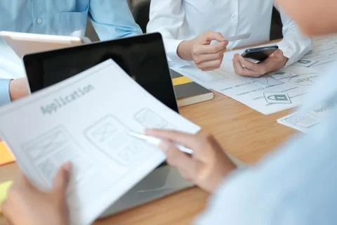 User experience UX designer designing web on smart phone layout. UI developer Stock Photos