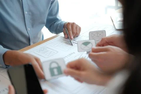 User experience UX designer designing web on smart phone layout. UI developer Stock Photos