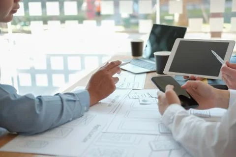 User experience UX designer designing web on smart phone layout. UI developer Stock Photos