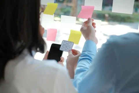 User experience UX designer designing web on smart phone layout. UI developer Stock Photos