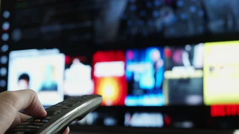 User Holding Remote To Control Smart TV Stock Footage 166804172