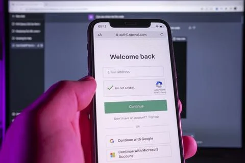 User holding SmartPhone, while doing login to ChatGPT service. Stock Photos