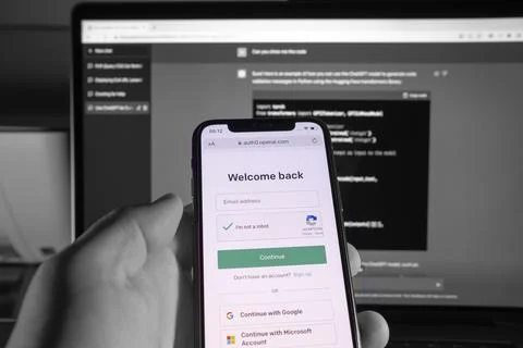 User holding SmartPhone, while doing login to ChatGPT. Developed by OpenAI. Stock Photos