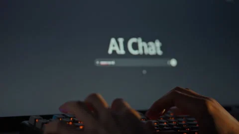 A user initiates a conversation with an AI model by typing on the keyboard l Stock Footage 335125081
