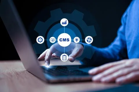 User interacting with a Content Management System on a laptop in a dark setting Stock Photos