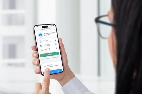 User interacting with habit tracker app on smartphone, productivity and sel.. Stock Photos