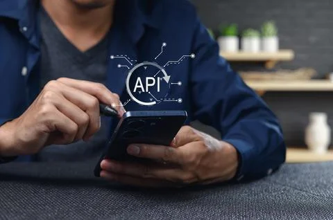 User Interacting with Smartphone Showing API Programming Interface Concept Stock Photos