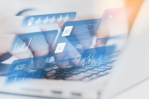User interacts with digital interface on a laptop while managing data and tasks 스톡 사진