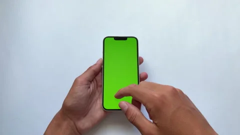 User interacts with green screen smartphone for powerful real-time data. Stock Footage 338188513