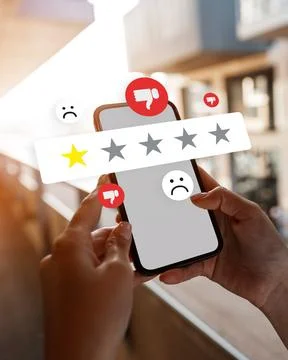 User interacts with mobile phone to leave a rating or review in a modern setting Stock Photos