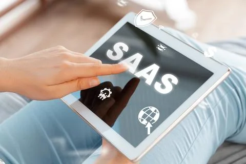 User interacts with SaaS platform on tablet device in a modern workspace Stock Photos
