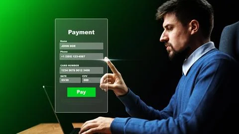 User makes an online payment using a laptop at home with a payment screen Stock Photos