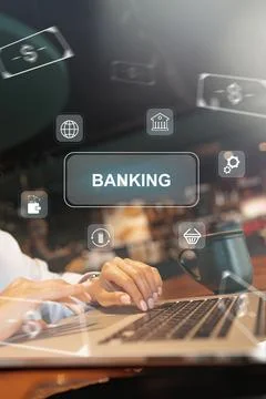 User making banking payments on a laptop with icons in background at a coffee Stock Photos