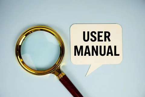 User Manual text on speech bluble with magnifying glass top view on blue ba.. Stock Photos