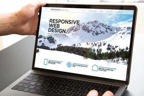 User opening laptop showing responsive web design Stock Photos