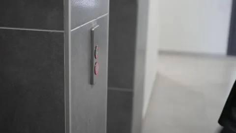 User presses elevator button in a building interior Stock Footage 345188678