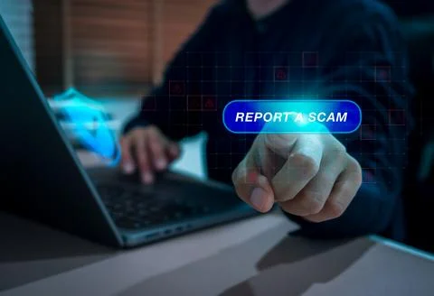 User pressing report a scam button on digital interface with warning icons .. Stock Photos