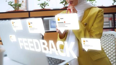 User provides feedback while using laptop in a modern workspace Stock Photos