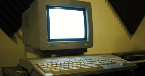 User putting floppy disk inside a retro Atari desktop computer - 80s vintage Stock Footage 148489605