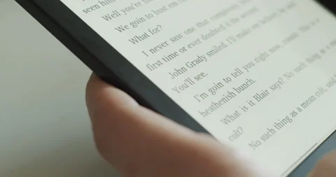 User reading electronic book on e-reader device - close-up Stock Footage 279821334