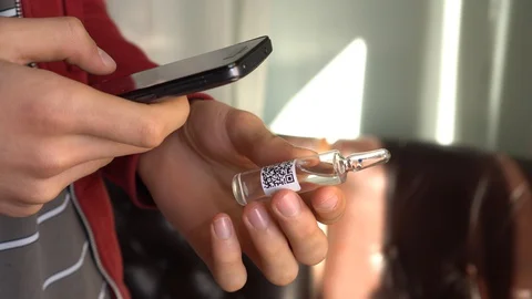 User scans the QR code to view information about a drug Stock Footage 129660046