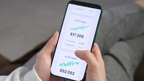 A user scrolling through financial growth projections on a smartphone. Stock Footage 327390201