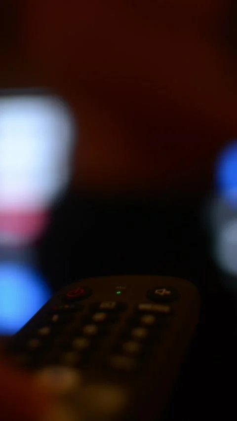 User scrolls through digital content on smart TV using remote control, browsing Stock Footage 320896814