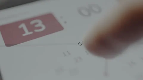 User setting the time for the upcoming event within the interface of the event Video stock 328813179