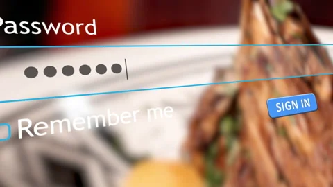 User submits password for account access with food in background Stock Footage 334022363