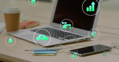 User tapping phone, open silver laptop showing animated finance icons, analyzing Stock Photos