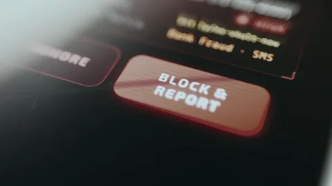 User taps the Block and Report action button to report fraudulent activity Stock Footage 334932168