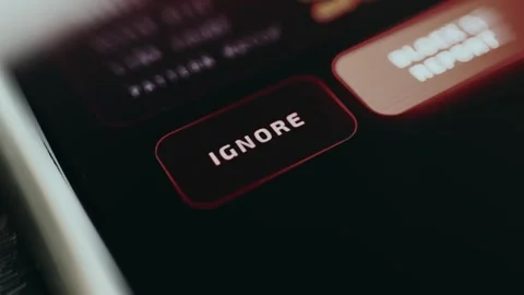 User taps the button labeled IGNORE to dismiss a threat alert Stock Footage 334932268