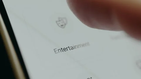 User taps the Entertainment category of expenses within the mobile app interface Video stock 330259260