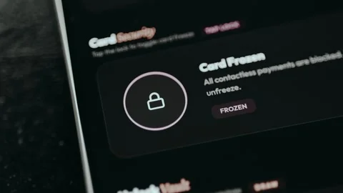User taps the lock icon to freeze the digital payment card Stock Footage 332498149