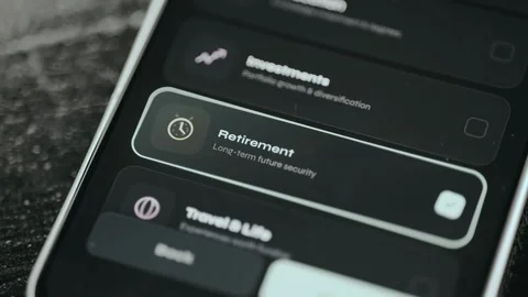 User taps the option labeled Retirement from a UI, long-term future security Stock Footage 332079393