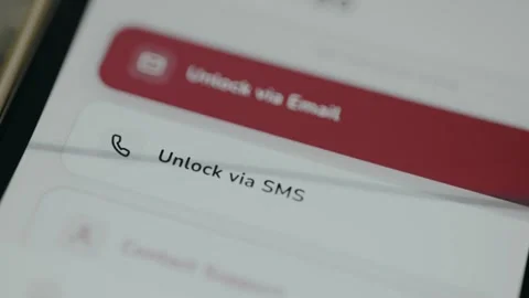 User taps the option labeled Unlock via SMS for a locked account Stock Footage 333383903