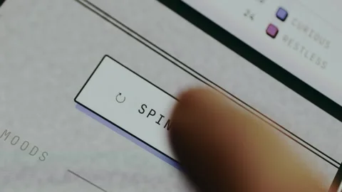 User taps the prominent SPIN ALL button with a refresh icon Stock Footage 334456689