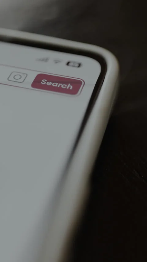 User taps the Search button within a search bar on the smartphone Stock Footage 328816282