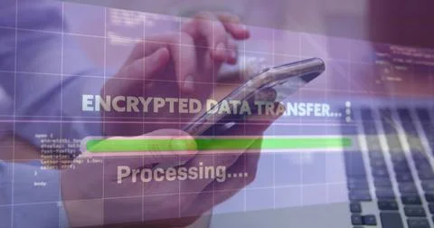 User transferring encrypted data on smartphone above laptop keyboard in office, 写真素材