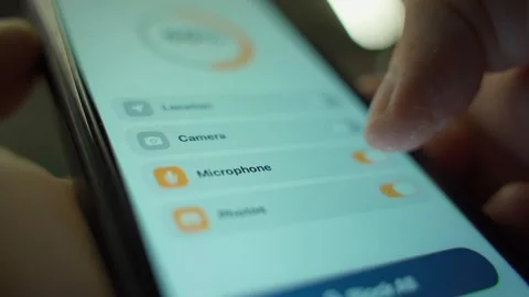 User turning off camera, microphone, location and photos through mobile app for Stock Footage 340388557