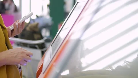 User uses smartphone while engaging with digital display Stock Footage 348531758