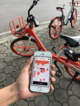 User is using application on iPhone for “mobike” rental bicycle Stock Photos