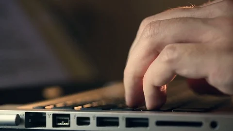 User's fingers typing on a laptop keypad and scrolling news Vidéo 80675301