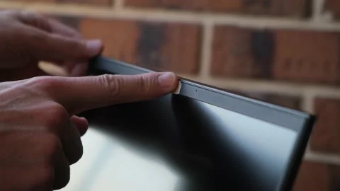 The user's hands are taping the webcam on the laptop, close-up Video stock 225451042