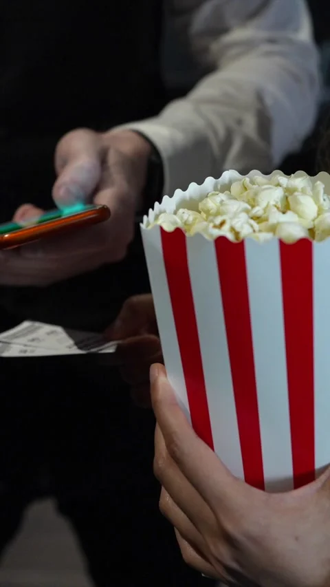 Usher scanning tickets and popcorn bucket at cinema Stock Footage 305838076