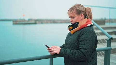 Using 5G mobile phone and getting text messages while standing outside Stock Footage 122247077