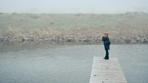 Using 5G phone to make a call while standing in rural area Stock Footage 122261477