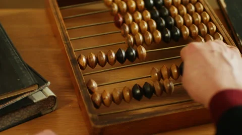 Using abacus or a counting frame on a table Stock Footage 49697215
